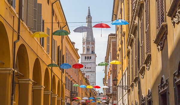 Umbrellas hanging in the street.